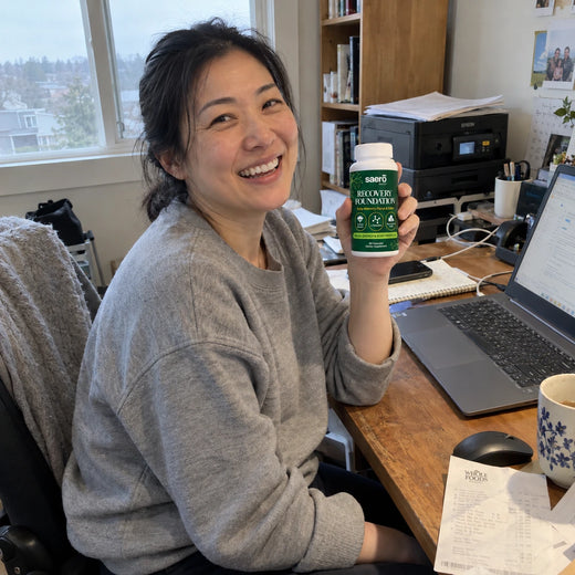 Customer at her desk, bottle by the laptop